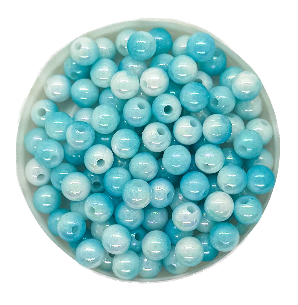 Perla plástica marmolada 6mm celeste x 10g